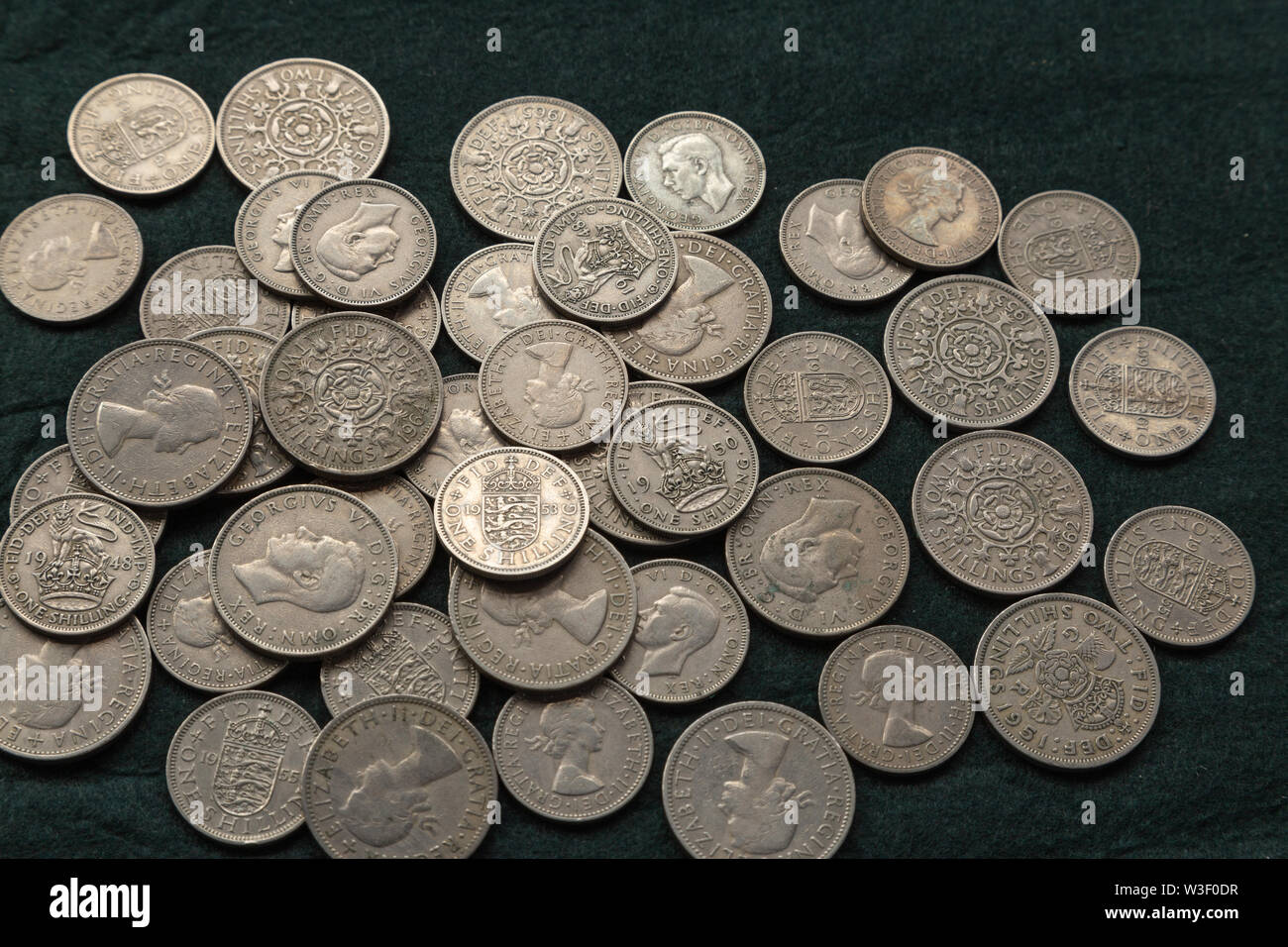 Mixture of old pre-decimalisation silver coins 1940's, 1950's & 1960's  shillings and 2 bob UK coins Stock Photo - Alamy