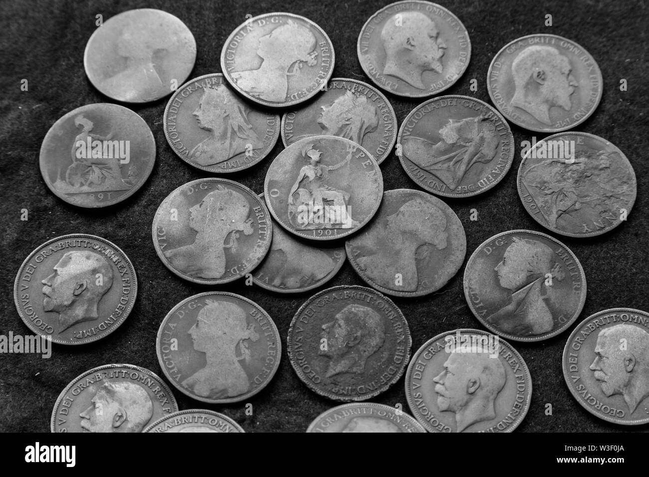 Old pre-decimalisation UK pennies. Queen Victoria and Edward VII old coins Black & White Stock Photo