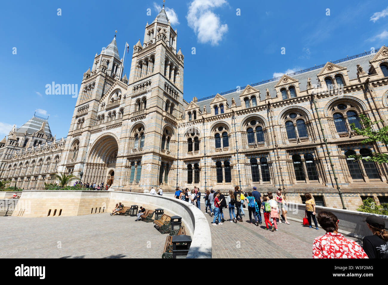 Natural History Museum London exterior; people outside entering the museum, via the main entrance on Exhibition road, South Kensington London UK Stock Photo