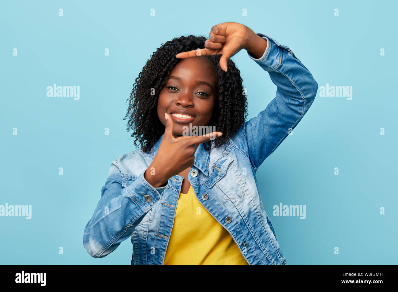 Happy Charming Woman Making Frame With Fingers Trying To Catch The Moment Pretends Taking Photo Isolated Blue Background Close Up Portrait Stock Photo Alamy