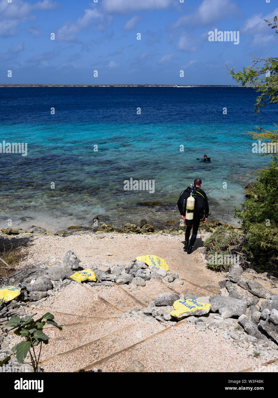 Diver entering the water at the Cliff dive site, Bonaire, Netherlands