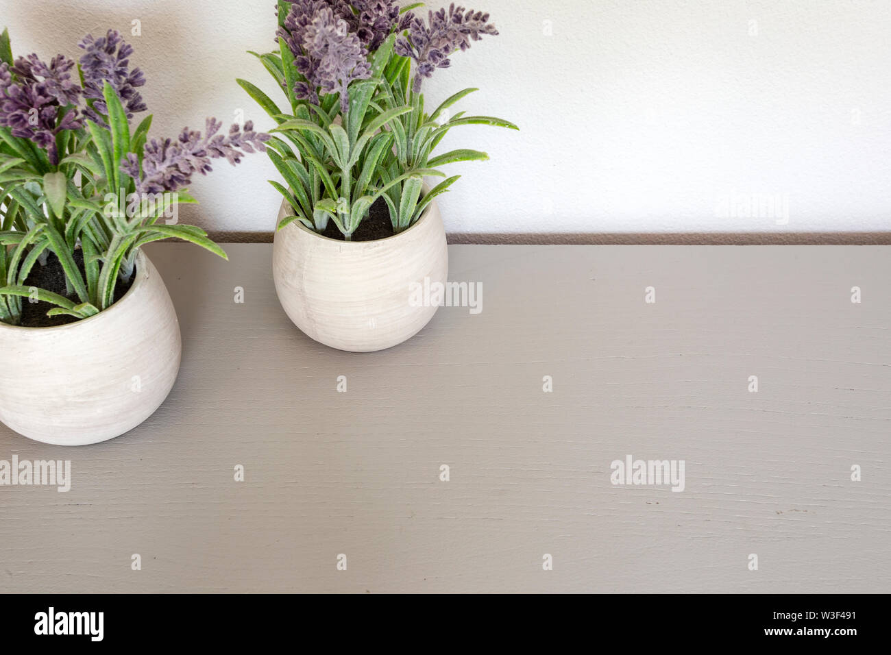 Bouquet of dry lavender in ceramic pot with white wall. Copy space for text. Stock Photo