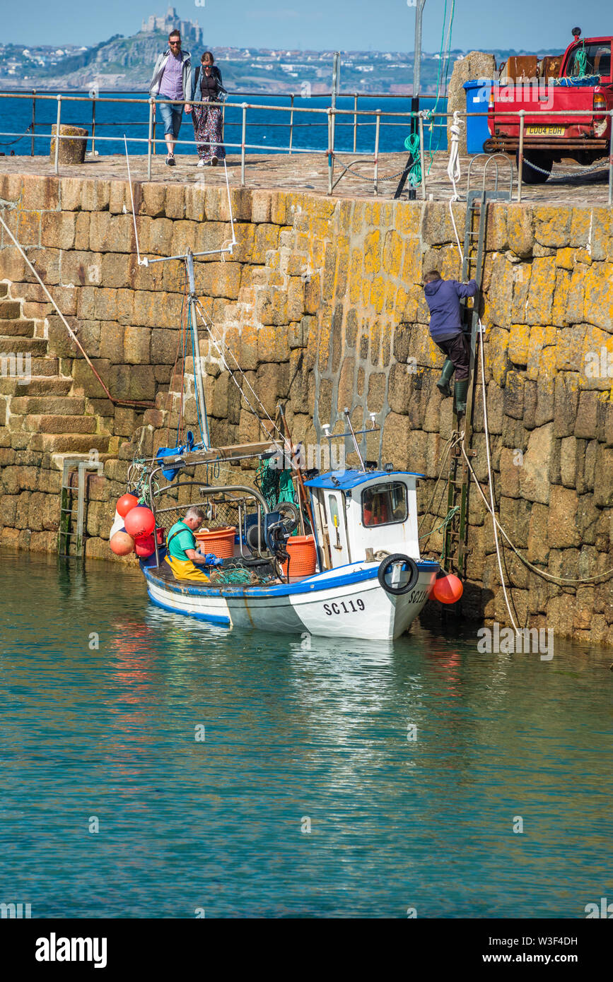 Small fishing boats in Mousehole harbour Cornwall England GB UK EU Europe Stock Photo