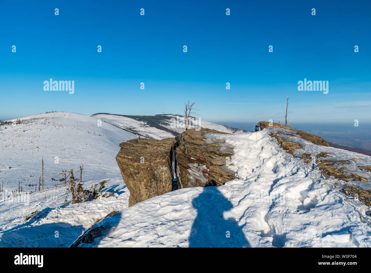 rock formation on Malinowska Skala hill with Skrzyzne hill on the background in Beskid Slaski mountains in Poland during wnter day with clear sky Stock Photo