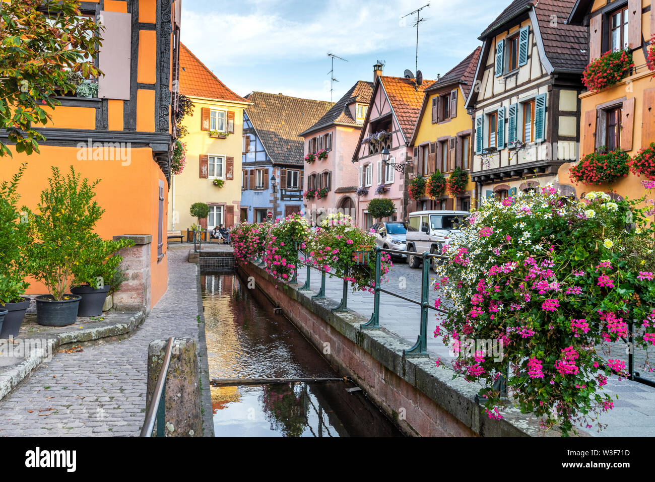 old timbered houses at a brook, wine village Ribeauvillé, Alsace Wine Route, France Stock Photo