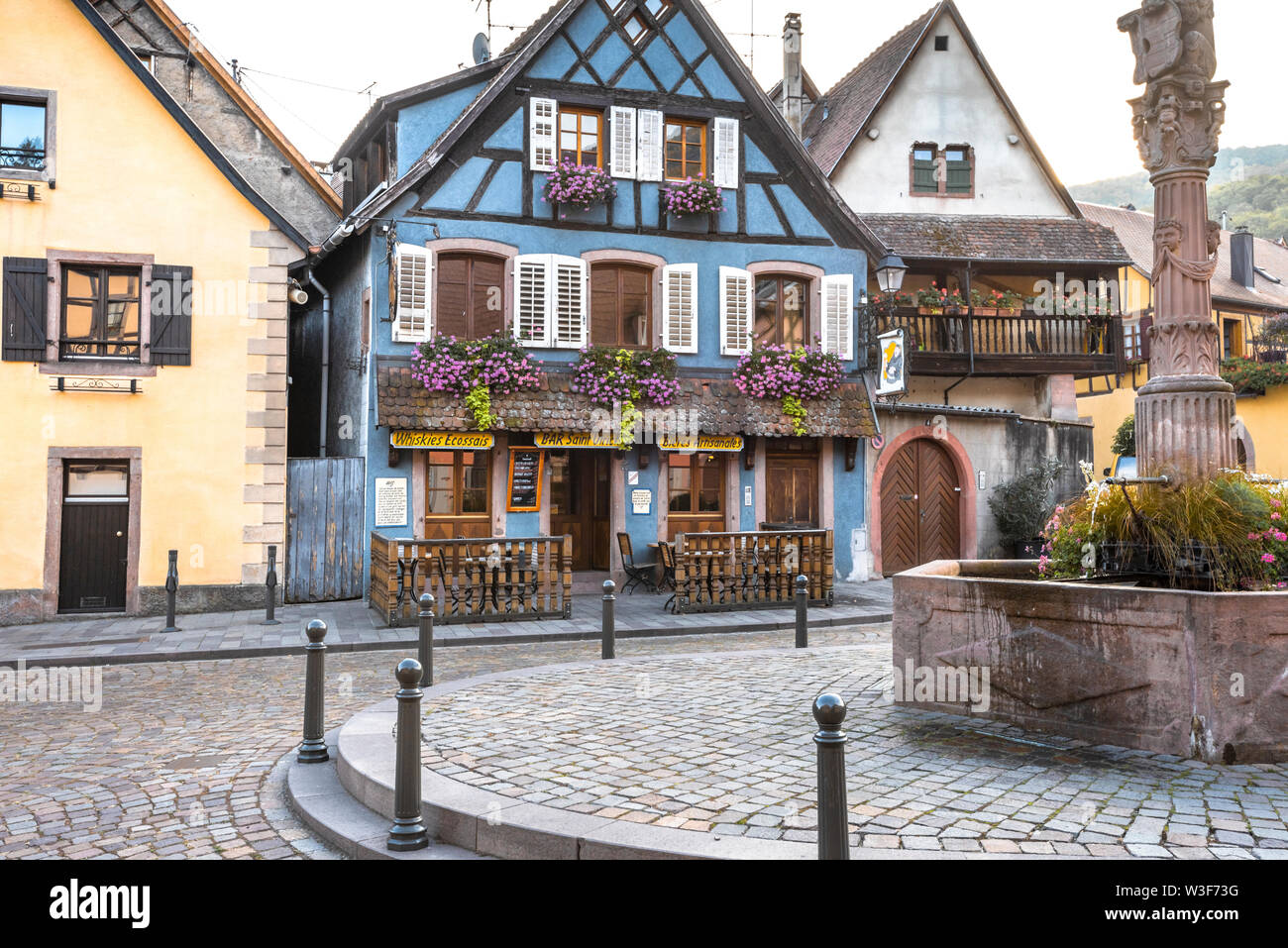 old timbered houses in the village Ribeauvillé, Alsace Wine Route, France, colorful houses around a well Stock Photo