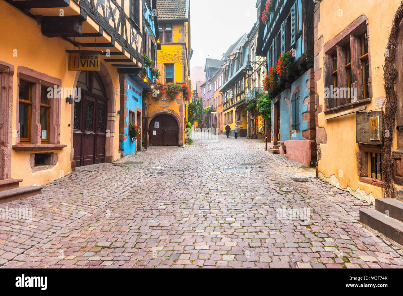 lane in the old town of Riquewihr, Alsace, France, medieval houses with autumn fog Stock Photo