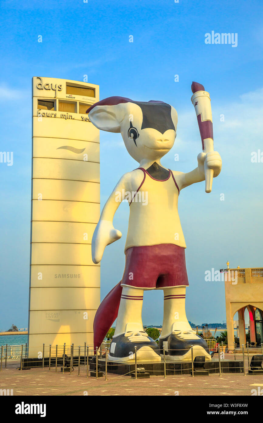 Doha, Qatar - February 23, 2019: Giant statue of Orry The Oryx at sunset light, mascot of the Asian Games 2006 along the Corniche in Doha West Bay Stock Photo