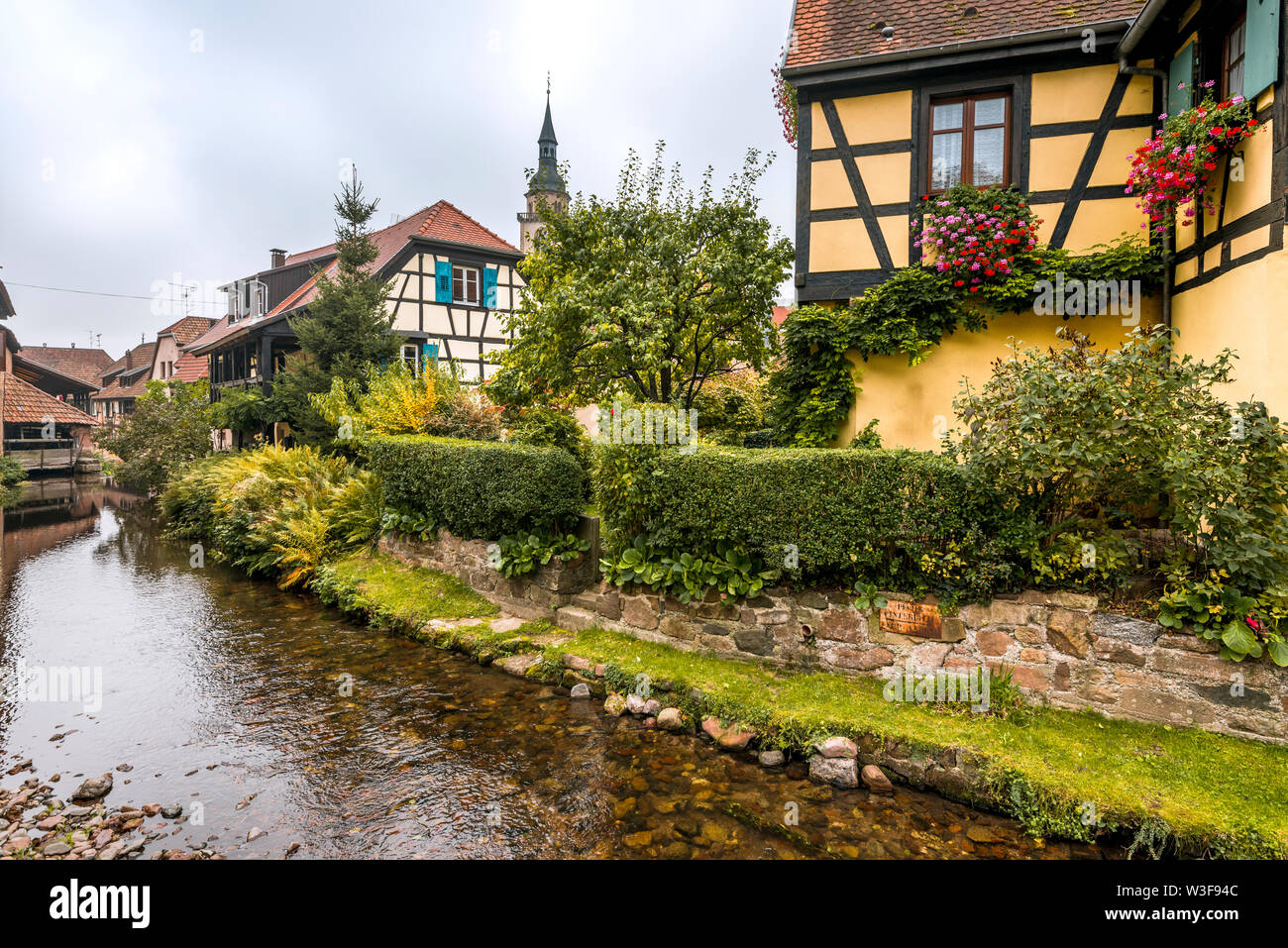 old village Andlau, Alsace Wine Route, France, half-timbered houses and flower decoration at the brookside Stock Photo