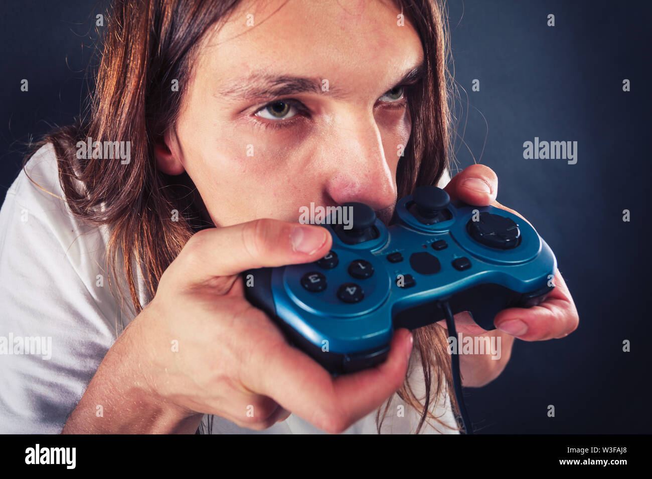 Lifestyle of young people. Student man spending time on playing games  videogames console playstation. Long haired guy focus on gaming Stock Photo  - Alamy