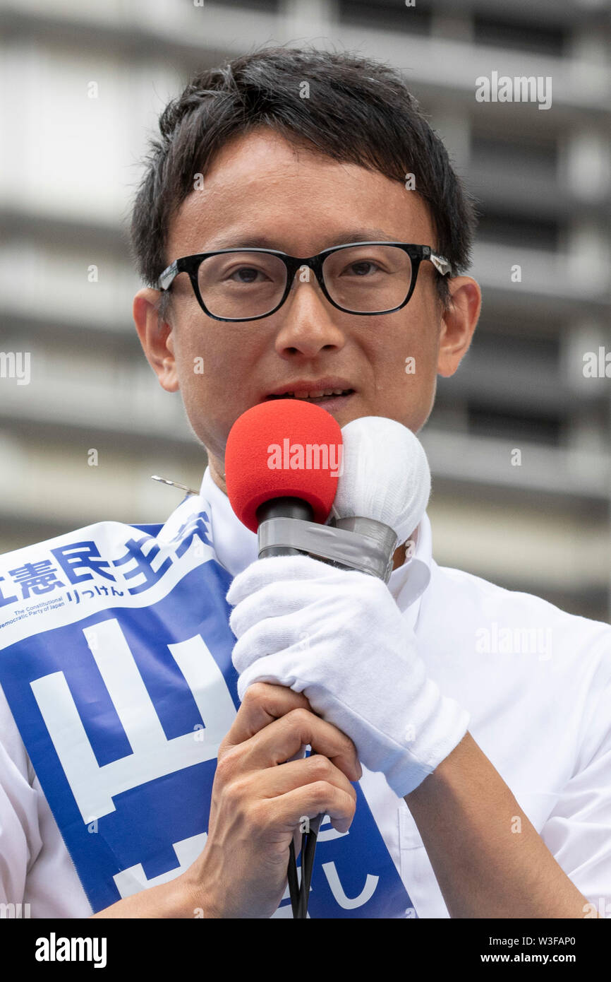 Tokyo, Japan. 15th July, 2019. Main opposition Constitutional Democratic Party of Japan (CDP) candidate Issei Yamagishi delivers a street speech outside Shinjuku Station. Yukio Edano leader of the Constitutional Democratic Party of Japan (CDP) showed support for the party fellow candidates for the July 21 House of Councillors election. Credit: Rodrigo Reyes Marin/AFLO/Alamy Live News Stock Photo