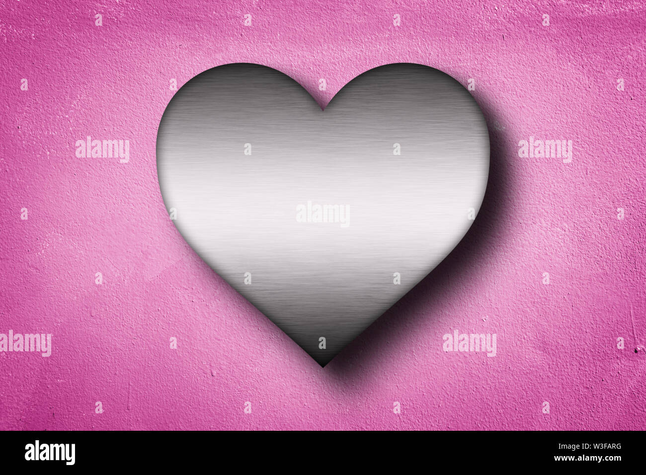 metal heart shape on pink concrete wall background . 3D rendering , love concept . Stock Photo