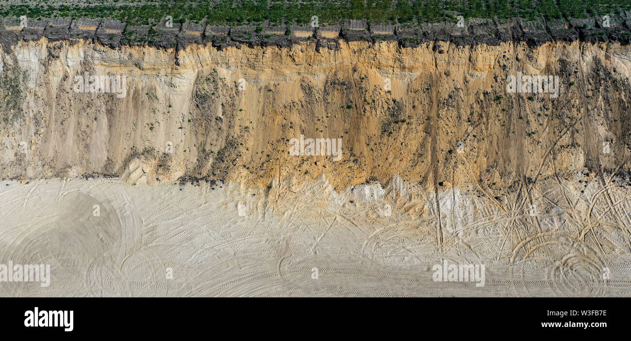 Aerial view of the steep high slope of a sand pit in Germany Stock Photo
