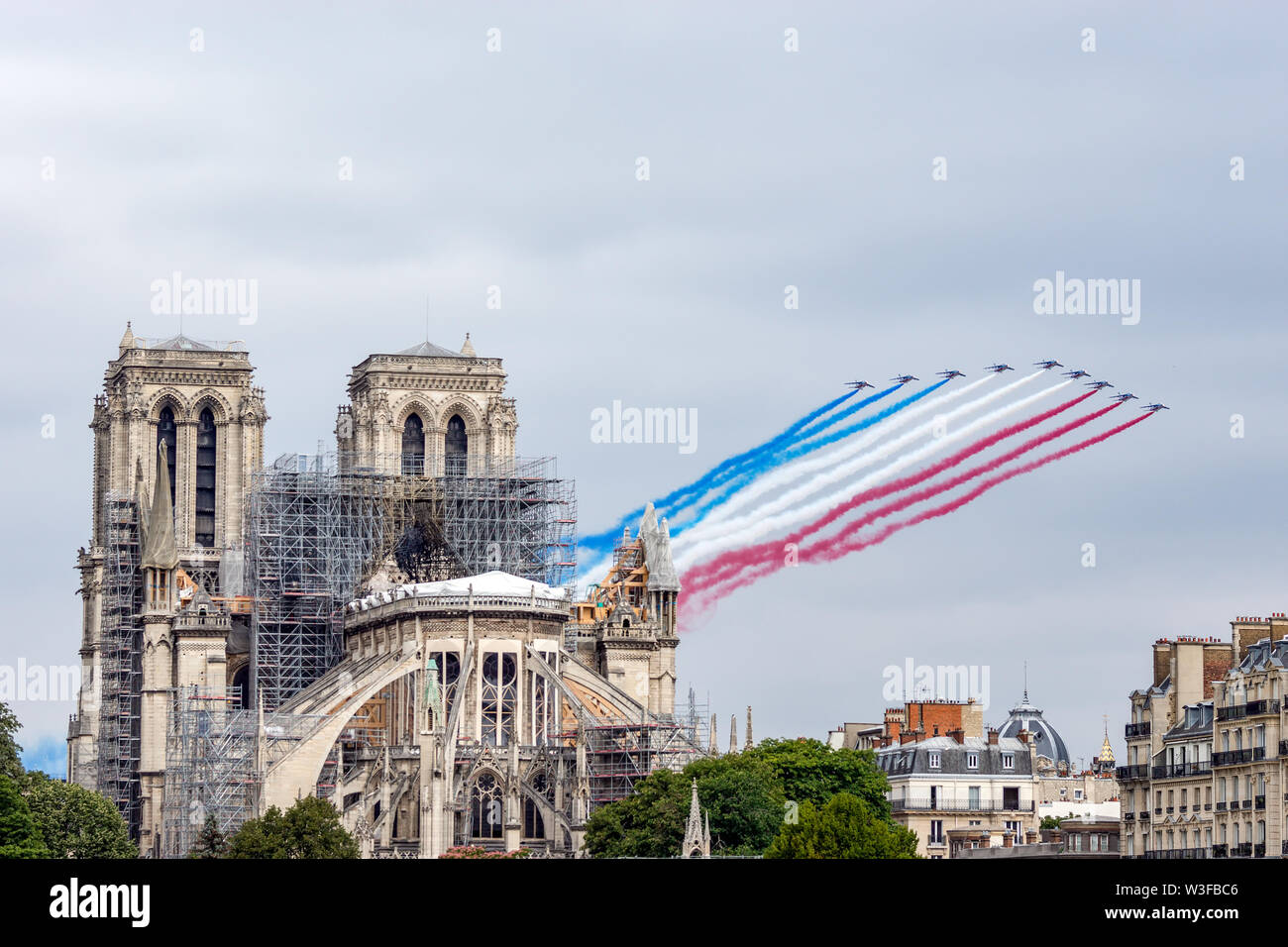 Bastille Day Aircrafts Parade over Notre Dame de Paris Stock Photo