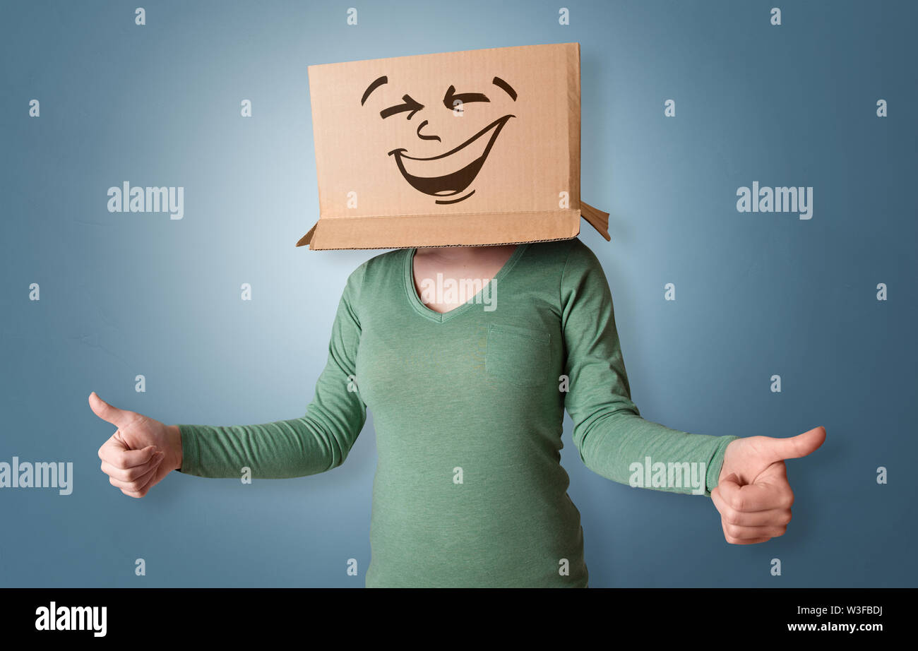 Young girl standing and gesturing with a cardboard box on her head