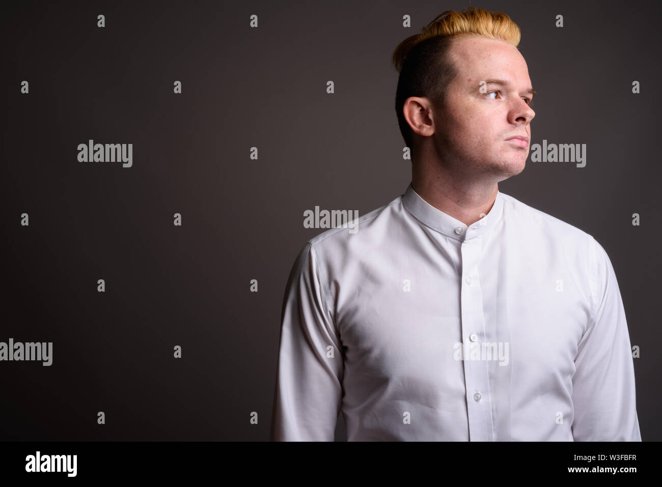Studio Shot Of Businessman With Mohawk Hairstyle And Blond Hair