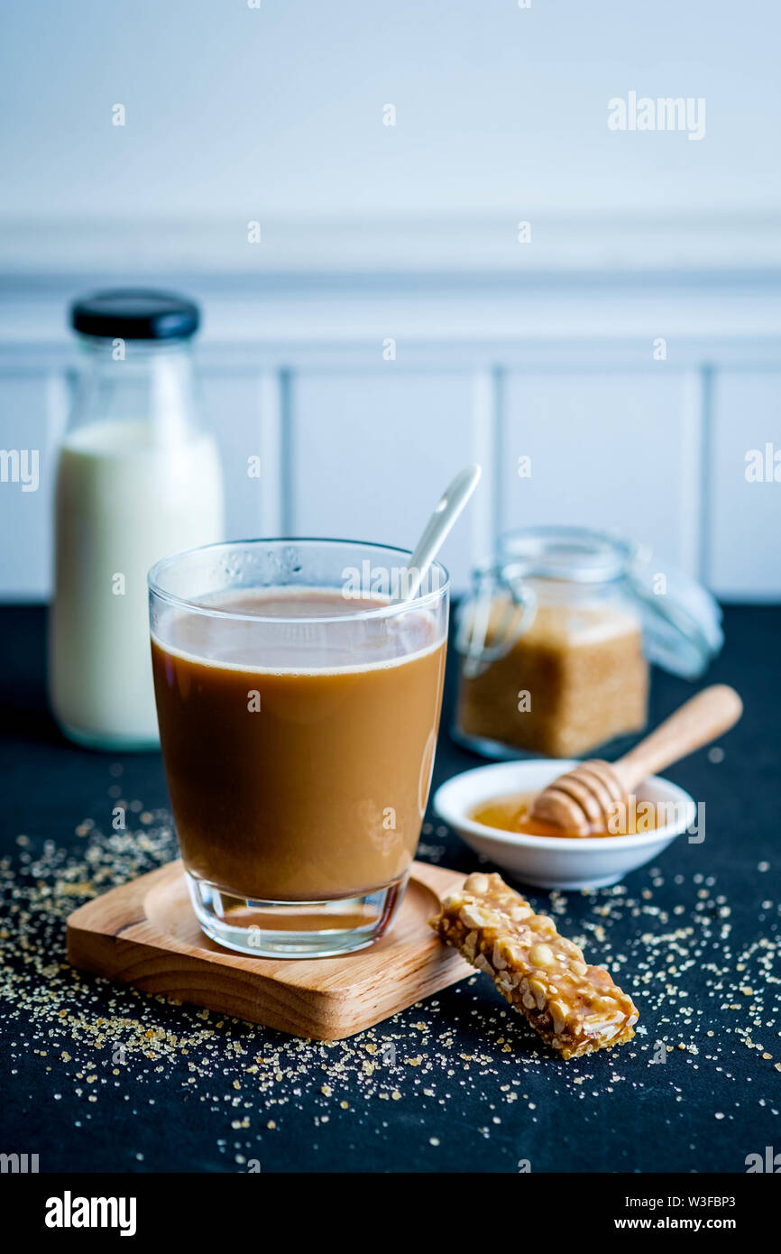 Glass of coffee with brown sugar honey milk Stock Photo
