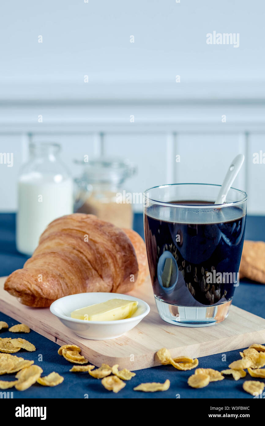 Glass of coffee with brown sugar honey butter milk cereals and croissant Stock Photo