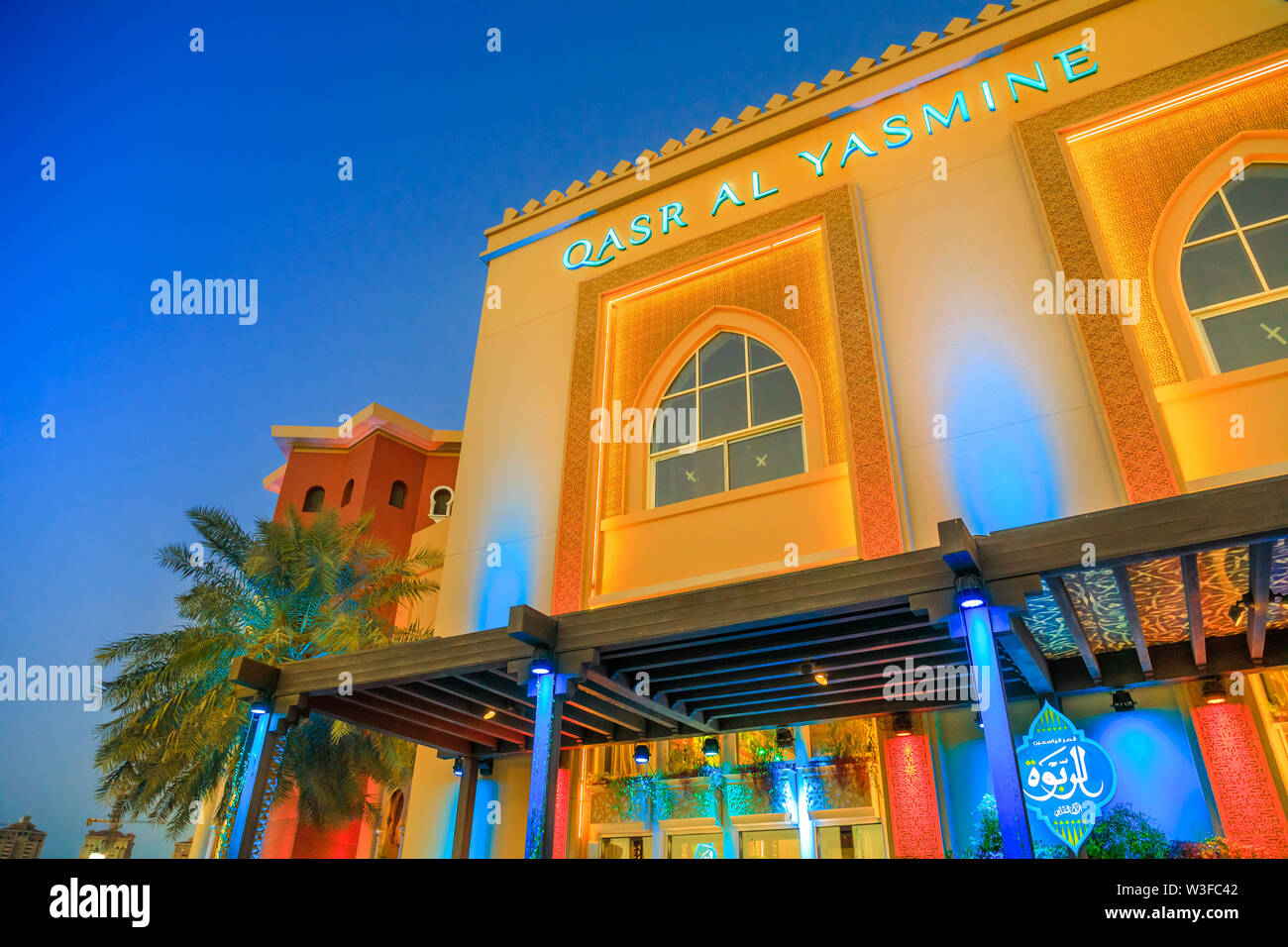 Doha, Qatar - February 18, 2019: facade of Arab restaurant Yasmine Palace on corniche marina promenade in Porto Arabia at the Pearl-Qatar, artificial Stock Photo