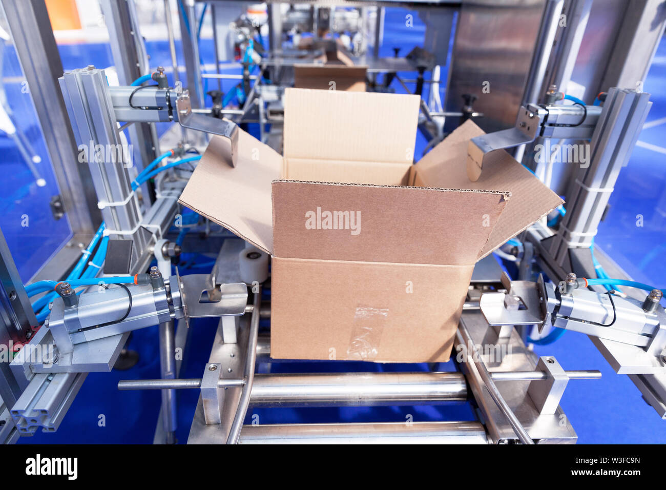 Automatic cardboard box erector machine Stock Photo Alamy