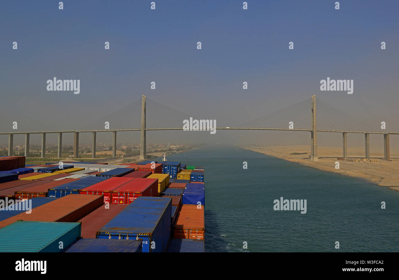 suez canal, egypt - january 06, 2105 -- the containership cma cgm vela ( imo 9354923)  transiting the suez canal  during a sandstorm, background:  sho Stock Photo