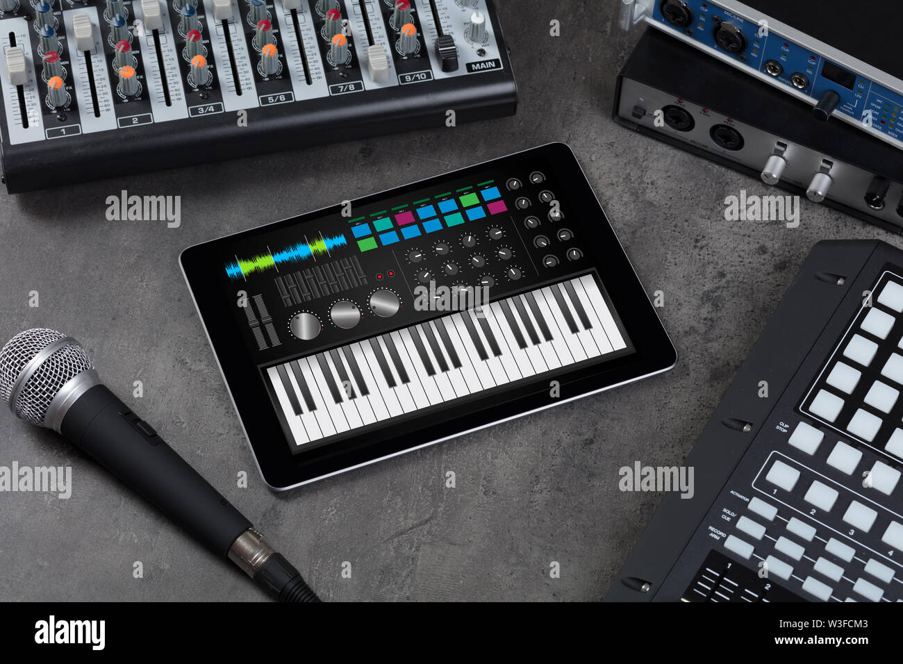 Piano synthesizer app on tablet and musical instrument concept Stock
