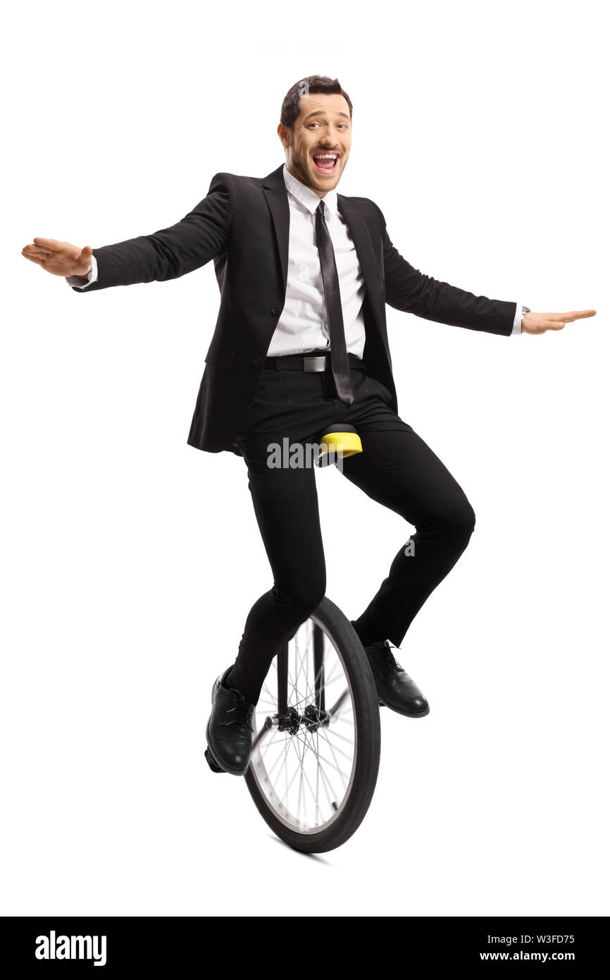 Full length portrait of a cheerful businessman riding a unicycle ...