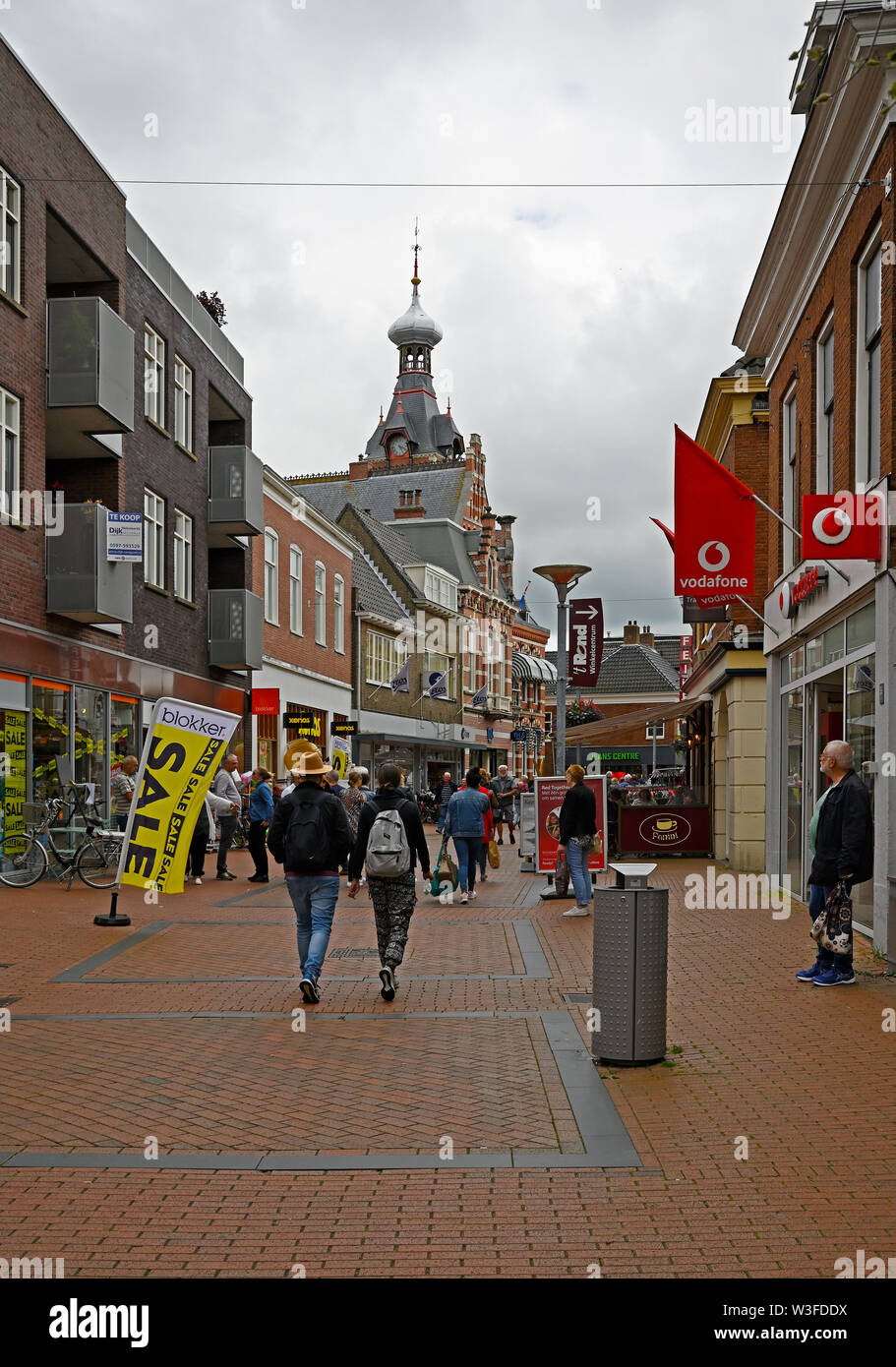 winschoten, netherlands - 2019.07.13:  people strolling on winschoten main shopping lane langestraat - background left: town hall building Stock Photo