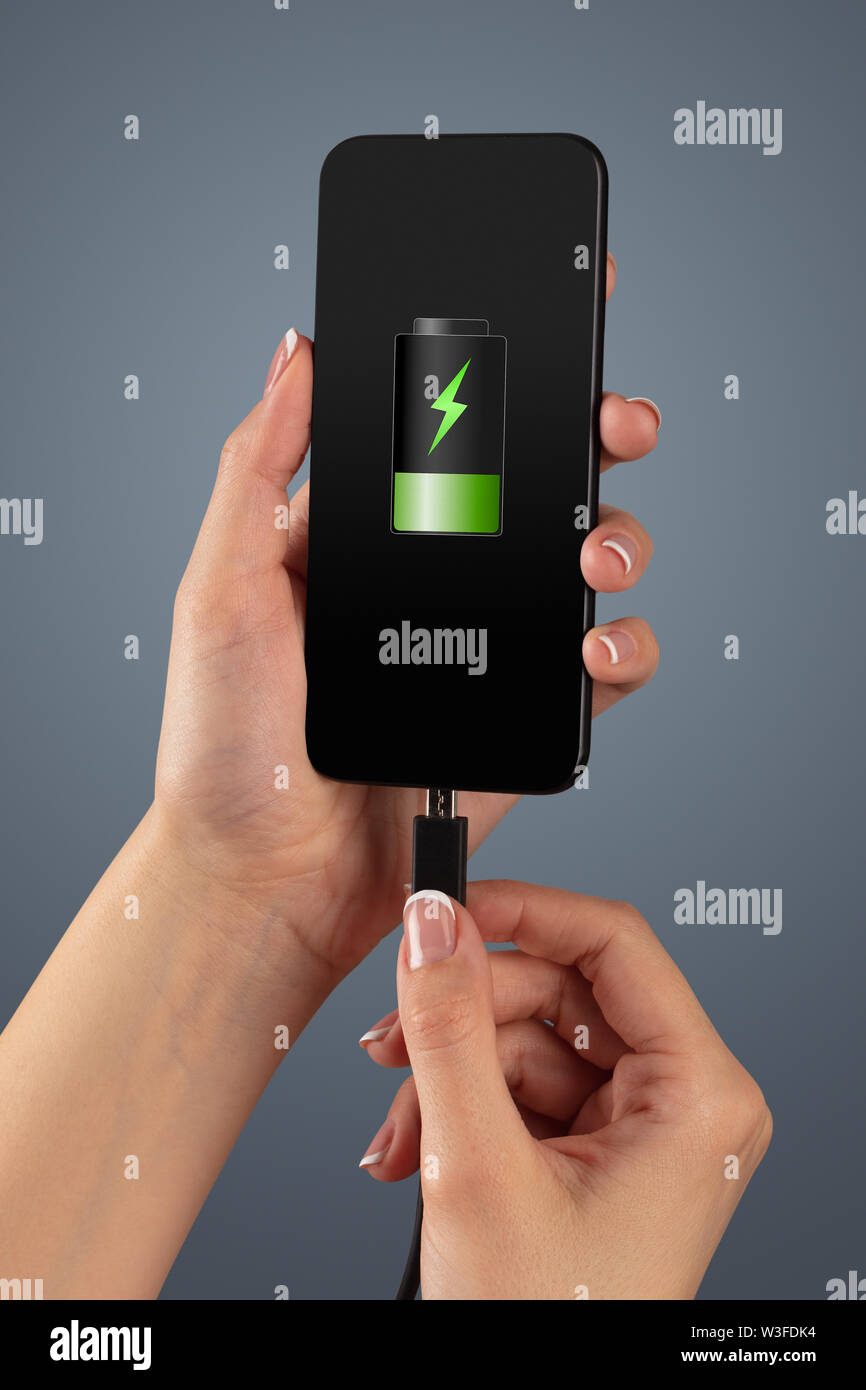 Elegant hand charging cellphone with low battery Stock Photo Alamy
