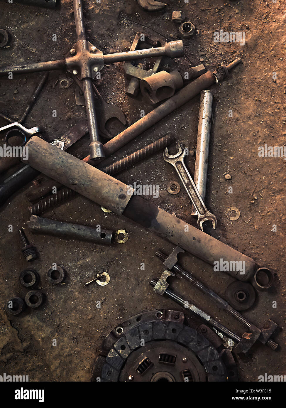 old parts and tools on the workshop floor Stock Photo