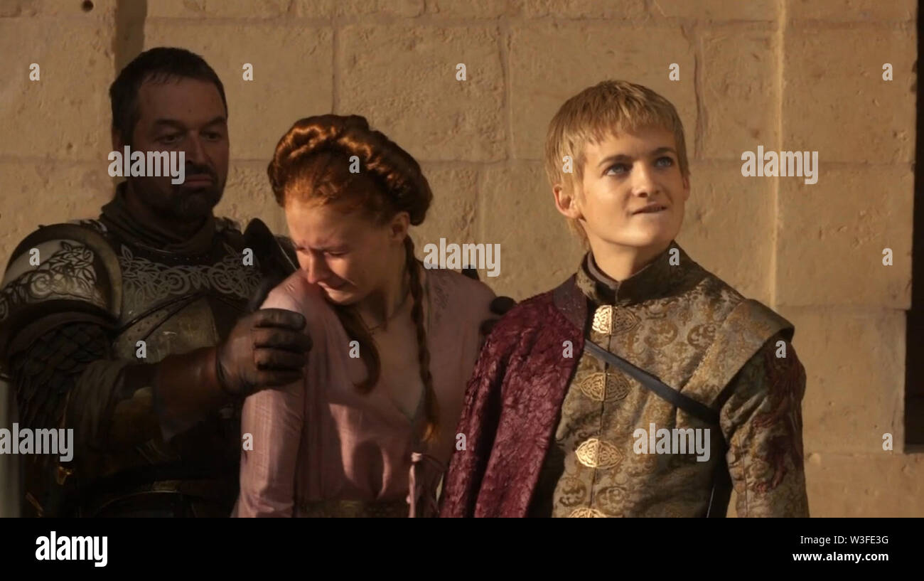 Los Angeles.CA.USA.  Sophie Turner as Sansa Stark with Jack Gleeson    as King Joffrey Baratheon and Ian Beattie as Ser Meryn Trant  in a scene from the ©HBO TV Series Game of Thrones (2011). S1E10.   Season Start: 2011. Ref:LMK112-SLIB191217-001 Supplied by LMKMEDIA. Editorial Only. Landmark Media is not the copyright owner of these Film or TV stills but provides a service only for recognised Media outlets. pictures@lmkmedia.com Stock Photo