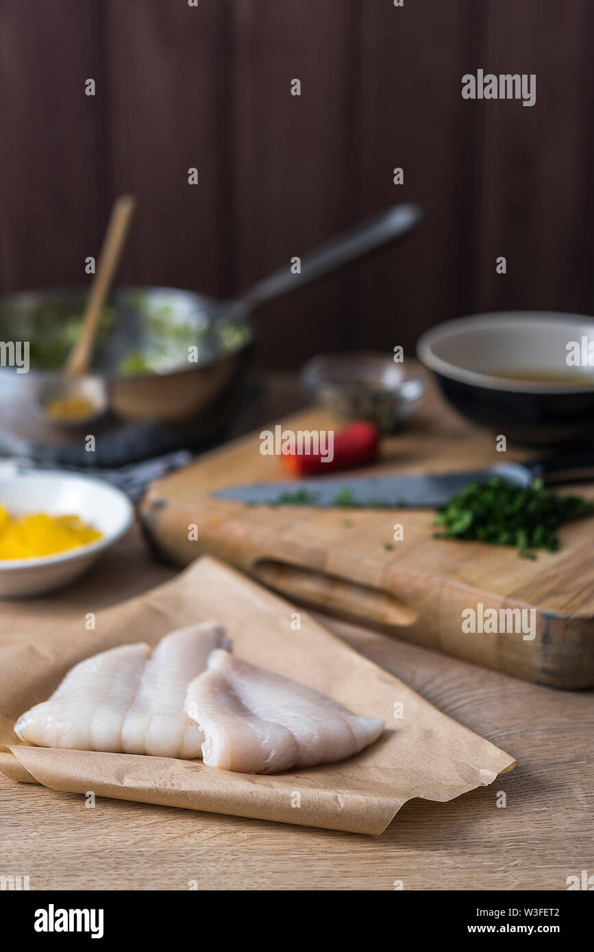 Raw Lemon sole fillets with oranges, herbs and chilli. Stock Photo