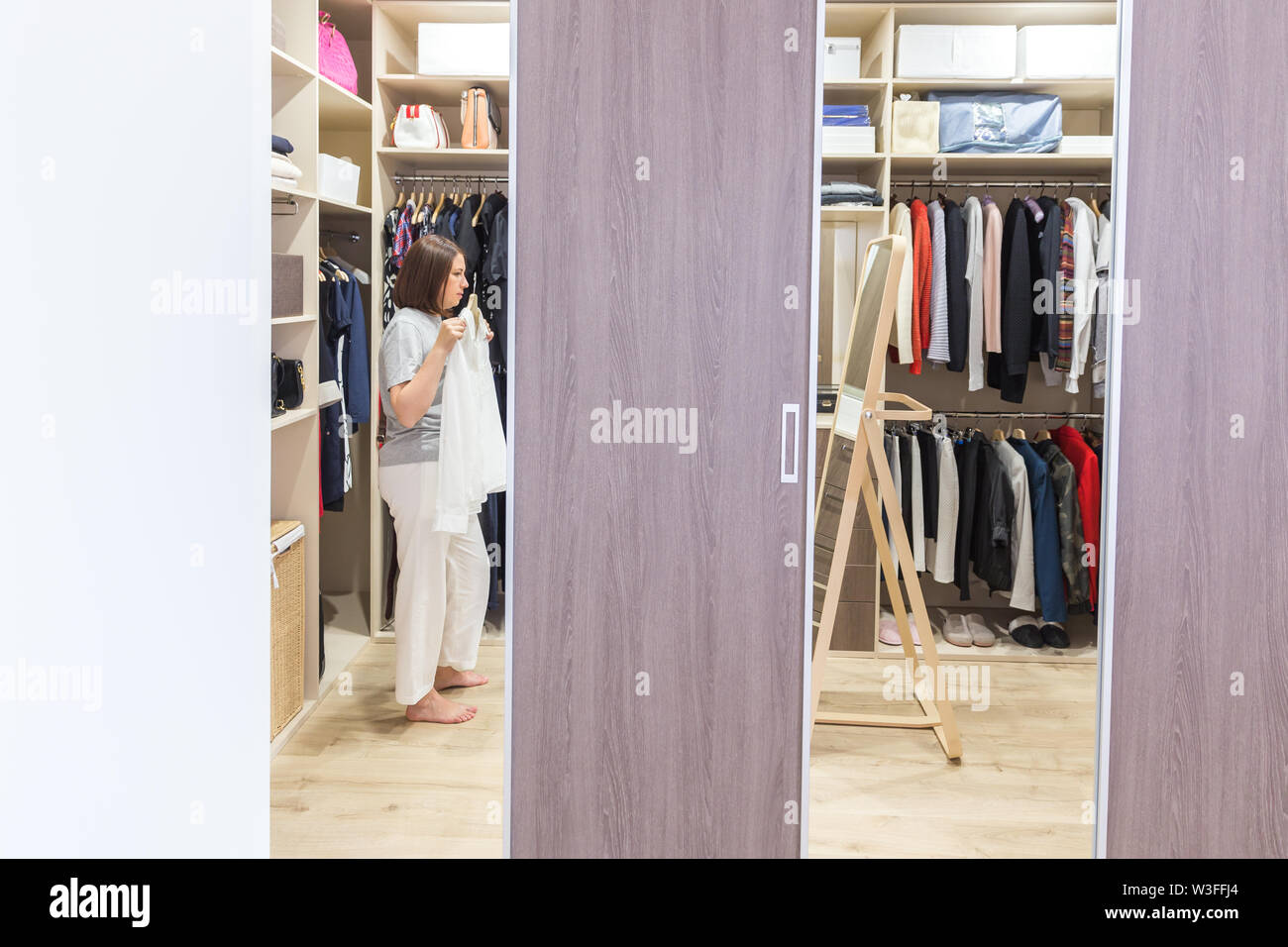 Woman In Big Walk In Closet Choosing Clothes Modern Wardrobe And