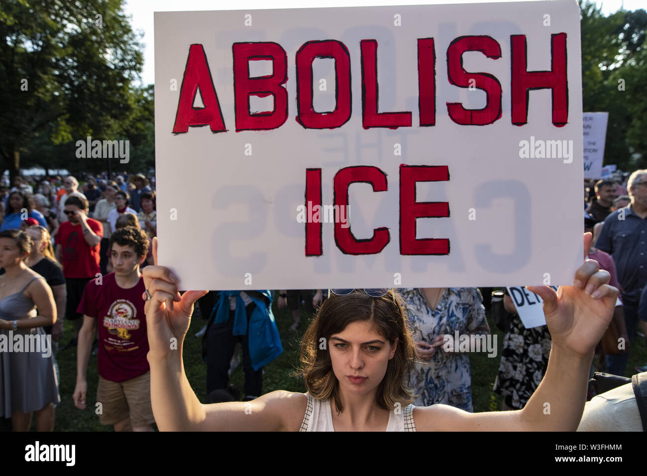 July 12, 2019 - Washington, District of Columbia, United States of America - A demonstrator holds an ''Abolish ICE'' protest sign during a vigil protesting treatment of migrant children by U.S. Immigration and Customs Enforcement (ICE) held near the White House in Lafayette Park in Washington, D.C. on July 12, 2019. (Credit Image: © Alex Edelman/ZUMA Wire) Stock Photo