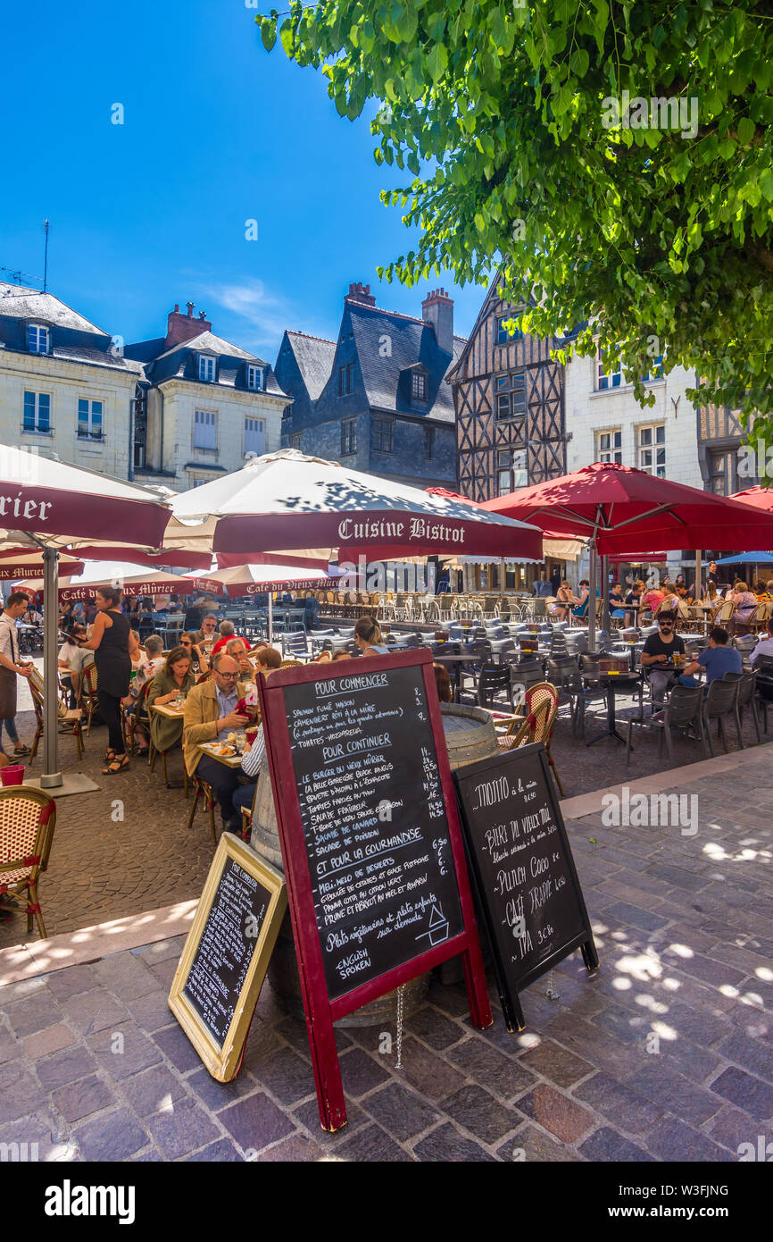 Tourists occupying cafes and restaurants in middle of Place Plumereau, Tours, Indre-et-Loire, France. Stock Photo