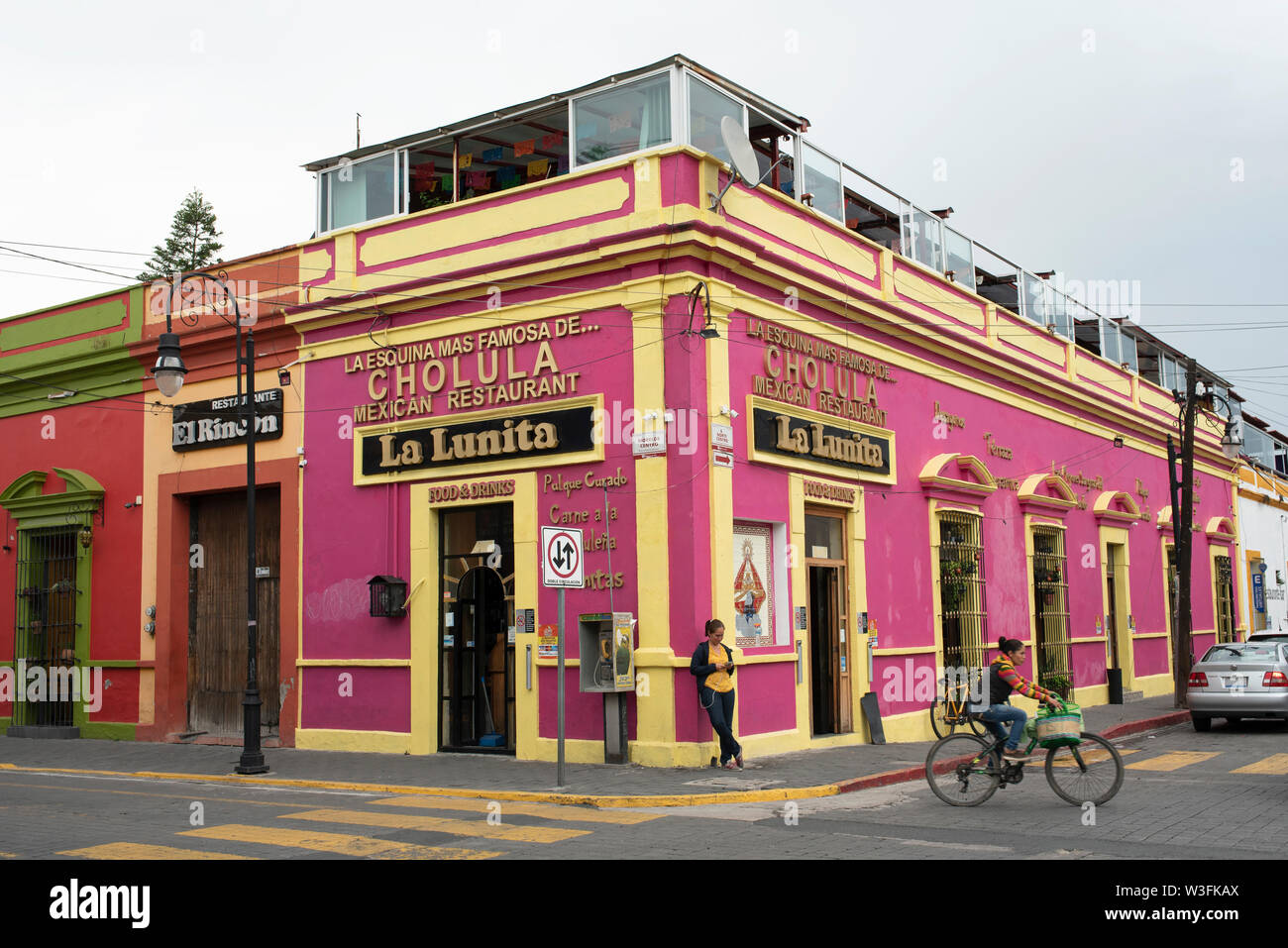 Bright painted colonial building with Mexican restaurant in downtown Cholula, near Puebla, Mexico. Jun 2019 Stock Photo