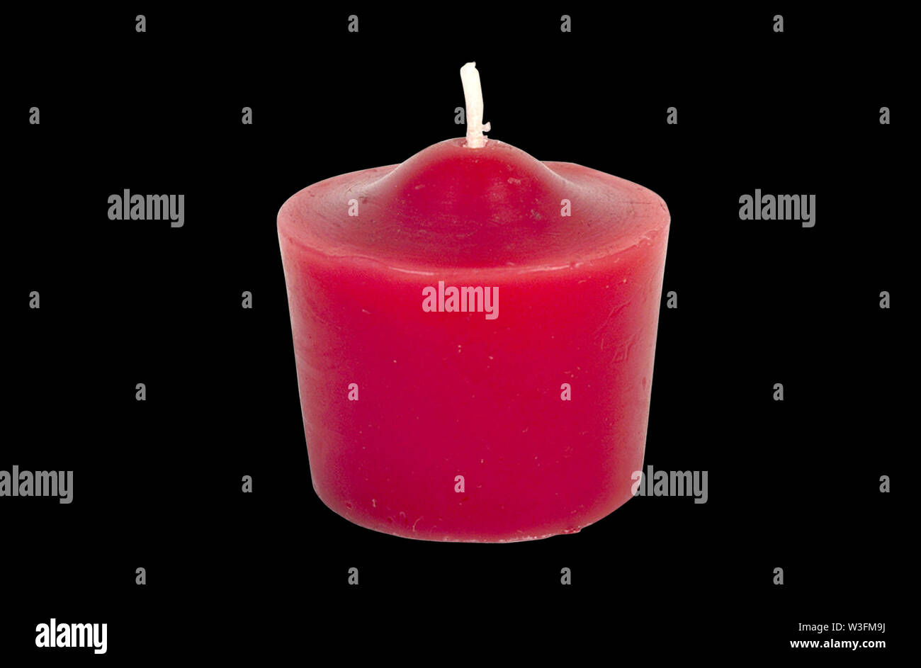 Red Wax Candle Isolated on Black Background. Stock Photo