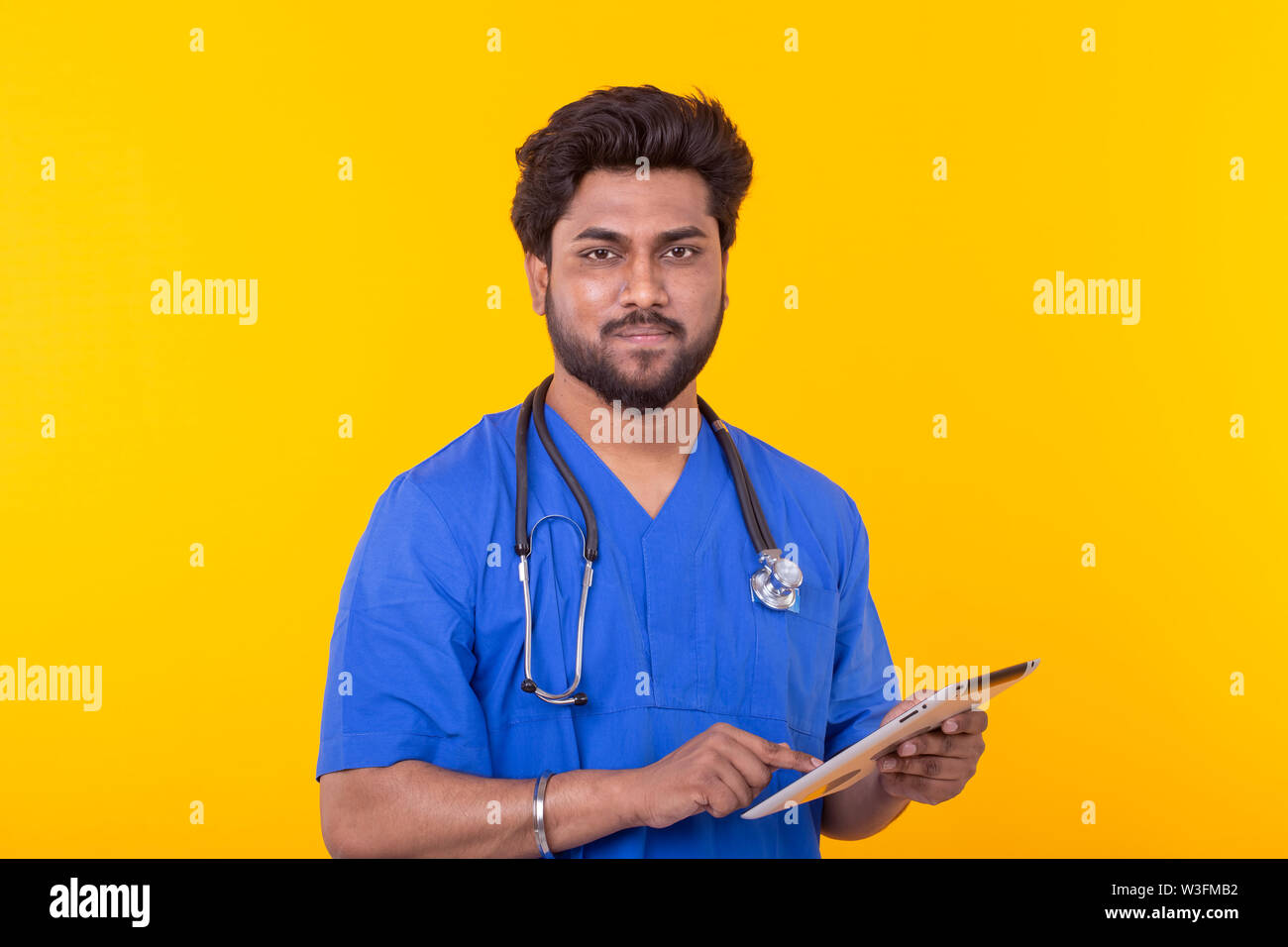 Cute Indian doctor in a blue robe with a stethoscope looking at a ...