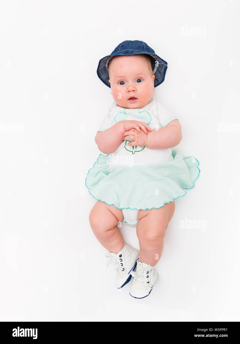 Happy cute 4 months old smiling baby in jeans hat on a white background.  top of view Stock Photo - Alamy