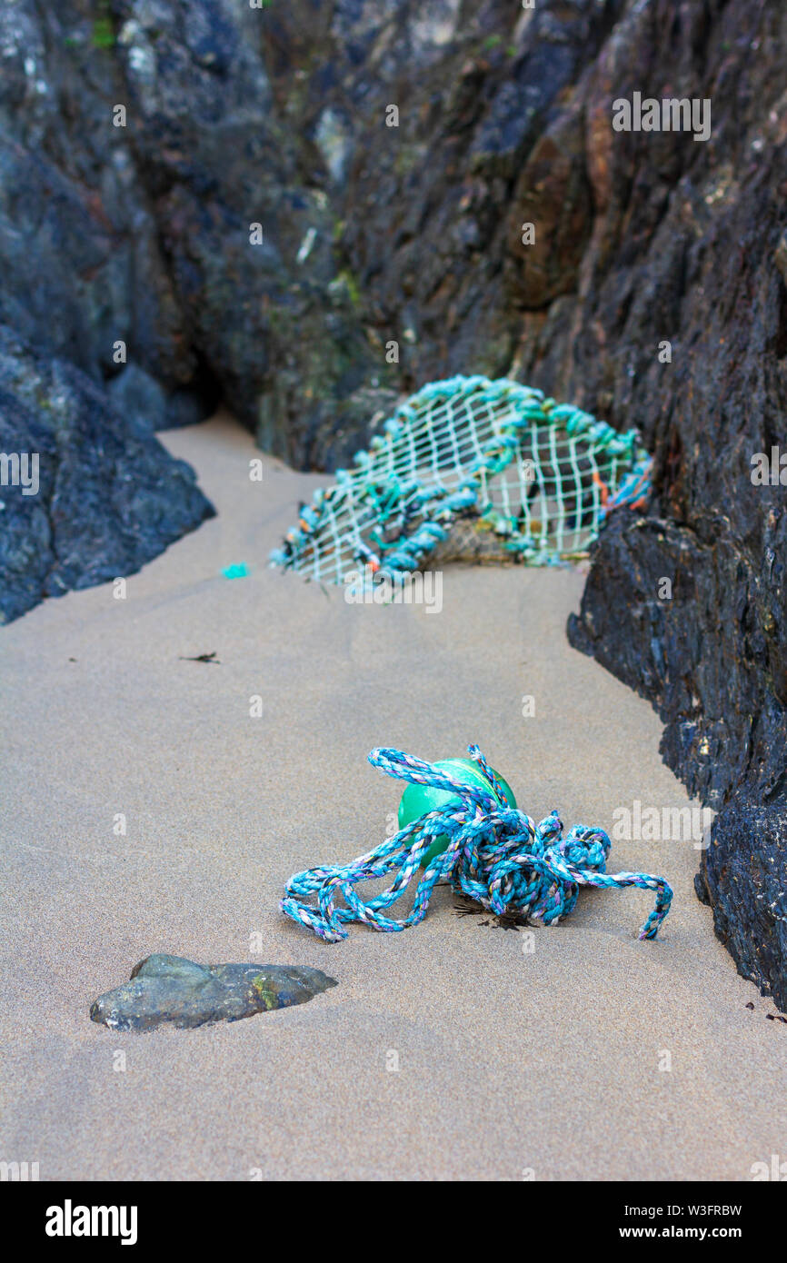 Rope and crab trap found in a small cove on Baginbun Beach, County Wexford, Ireland Stock Photo