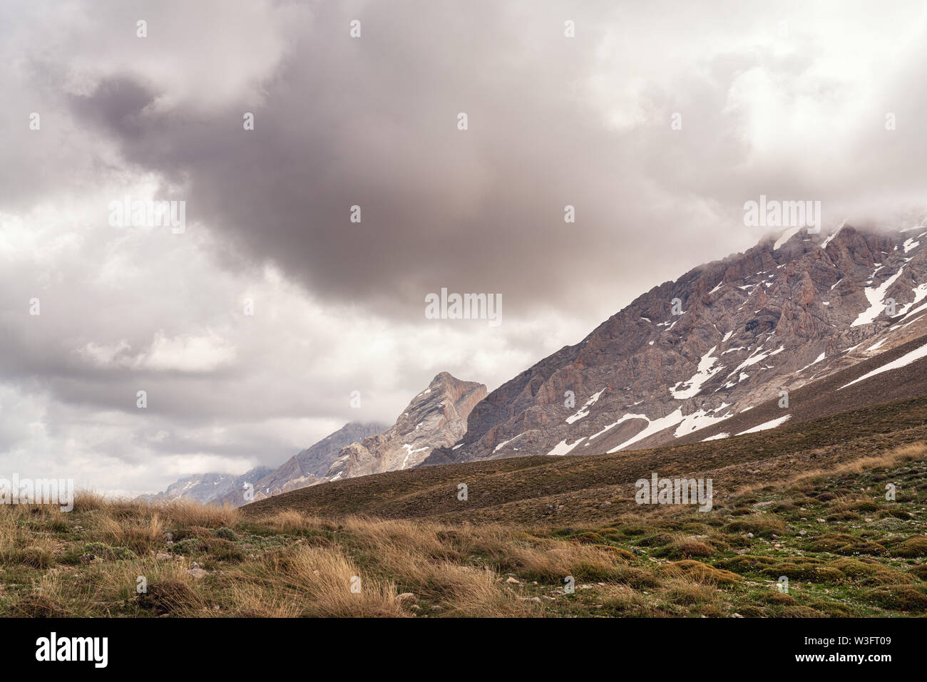 Snowy Mountain With Cloudy Sky In The Background Stock Photo