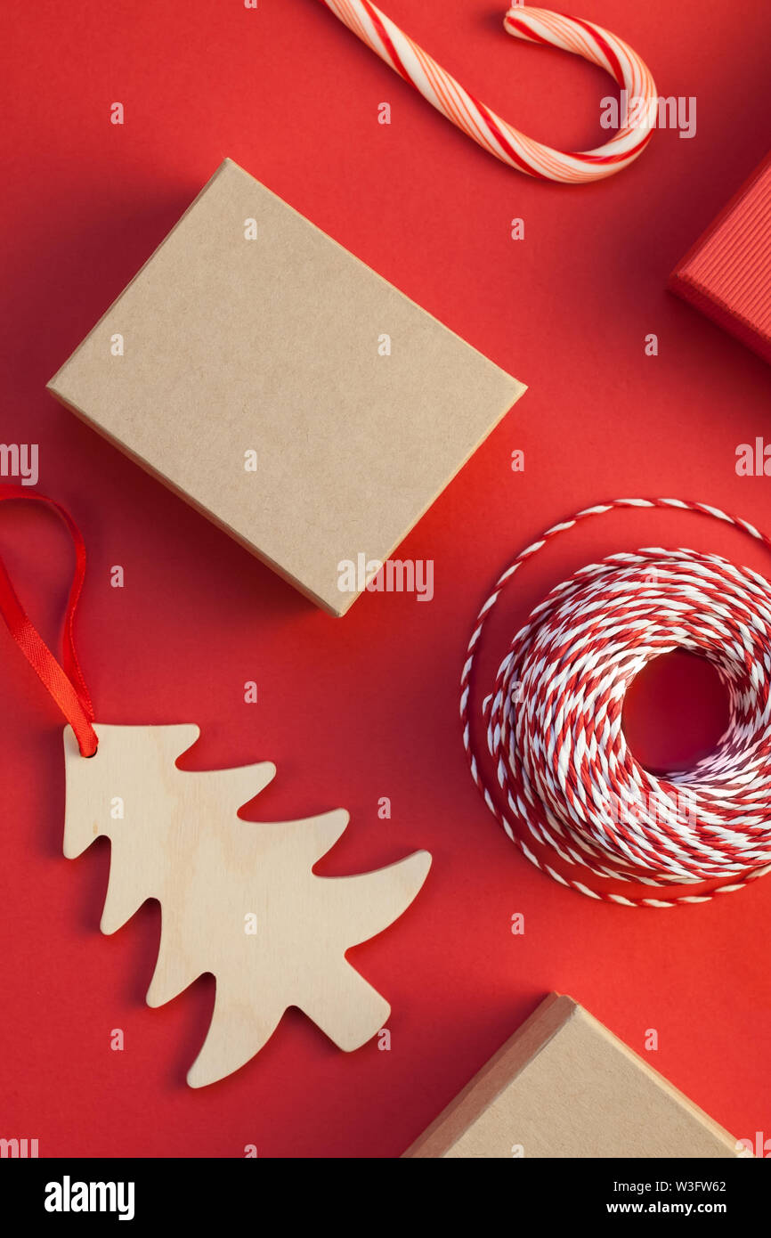 New Year or Christmas presents wrapped with ribbon flat lay top view Xmas 2020 holiday celebration handmade gift boxes on red paper background copyspa Stock Photo