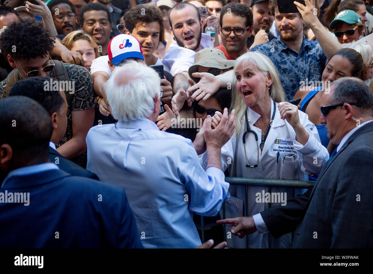 Philadelphia, Pennsylvania, USA. 15th July, 2019. Senator Bernie Sanders greets the crowd following a protest against the closure of Hahnemann University Hospital in Philadelphia, PA, July 15, 2019. Hahnemann, a busy urban healthcare center, is facing imminent closure after being acquired by a hedge fund that is looking to raze the building and turn the land into rental or retail properties. 15th July, 2019. Credit: Michael Candelori/ZUMA Wire/Alamy Live News Credit: ZUMA Press, Inc./Alamy Live News Stock Photo