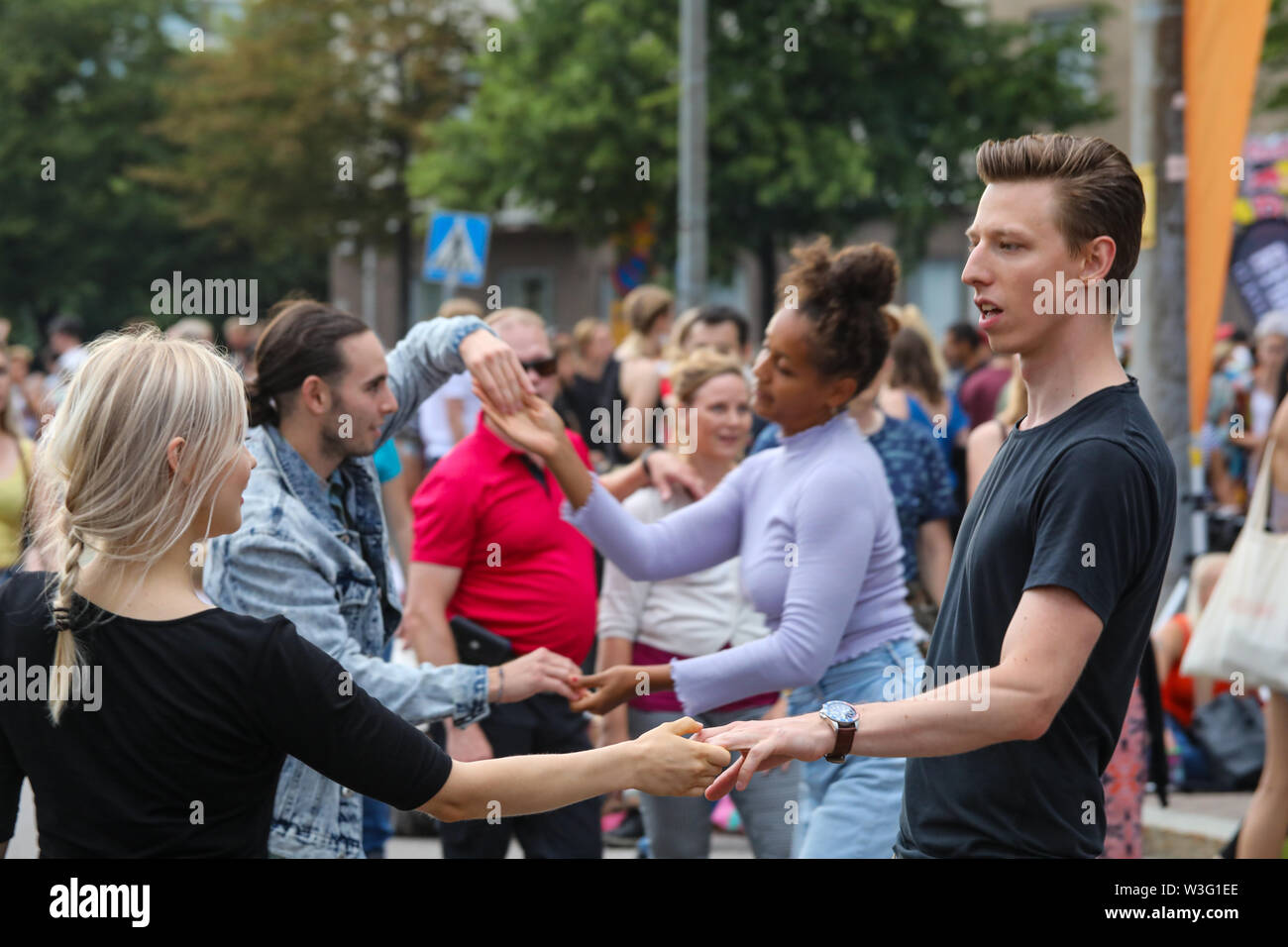 Couples dancing in the streets of Hakaniemi at Kallio Block Party in Helsinki, Finland Stock Photo