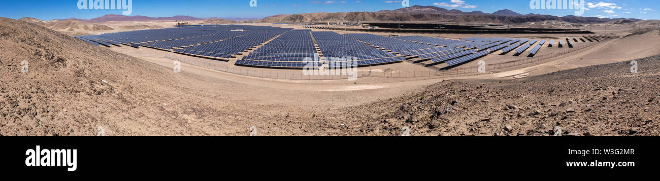 Hundreds solar energy modules or panels rows along the dry lands at Atacama Desert, Chile. Huge Photovoltaic PV Plant in the middle of the desert Stock Photo