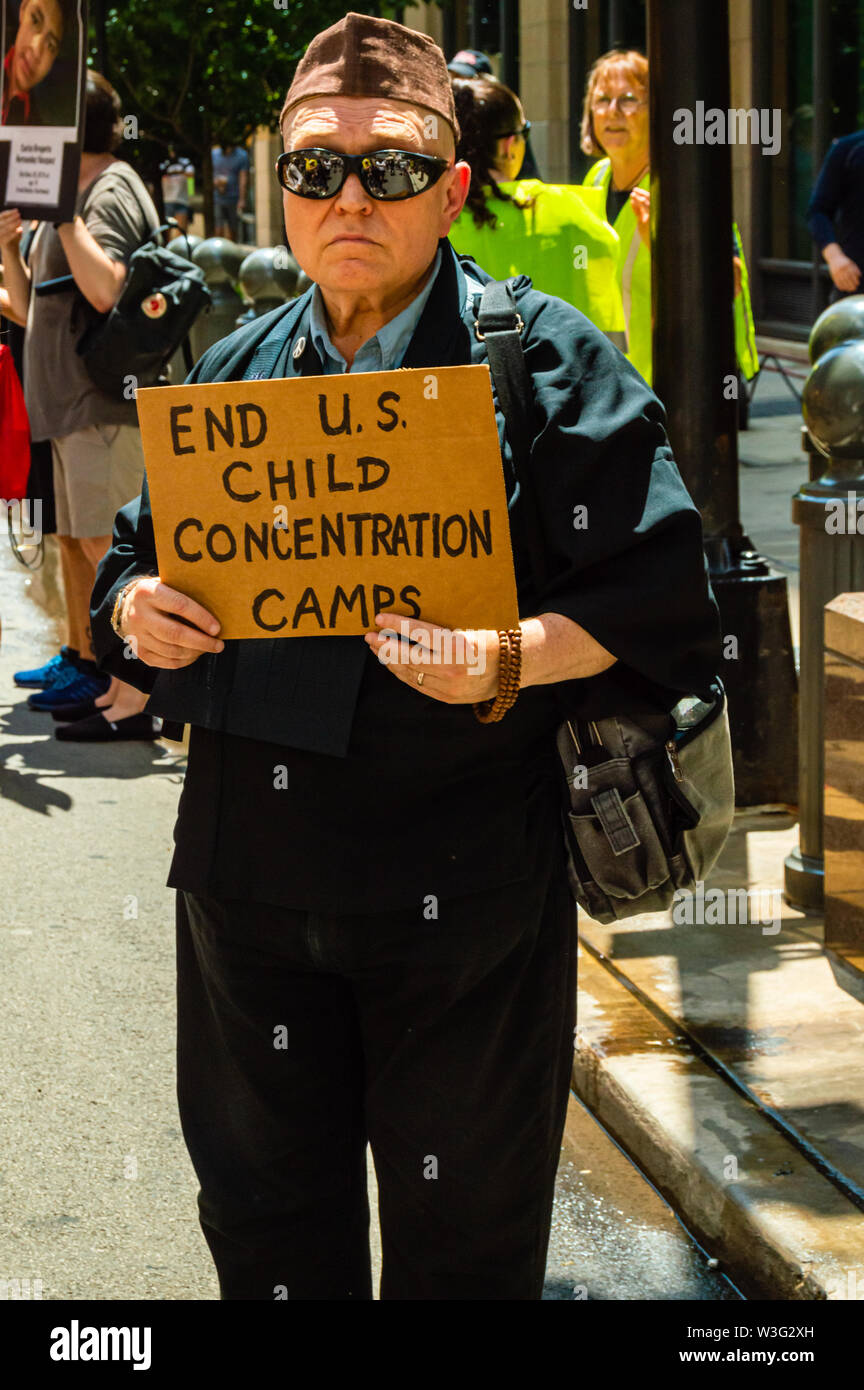 Downtown, Chicago-July 13, 2019: Protest against ICE and Customs and Border Patrol Detention Centers. A man holds a sign that reads 'End US Child Conc Stock Photo