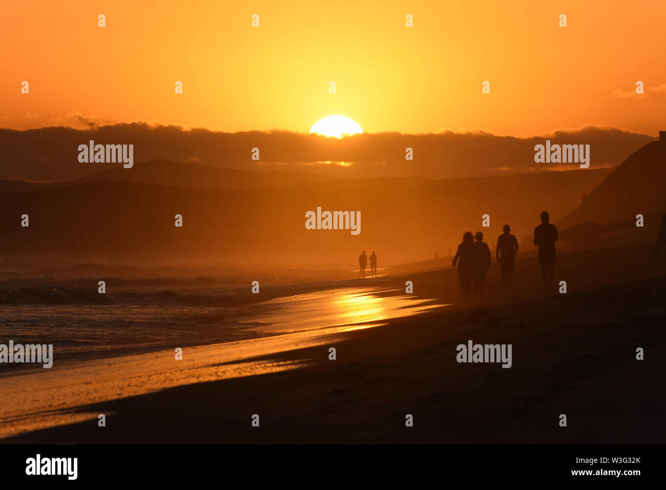 Orange Glow During Last Light On Sunset Beach Stock Photo