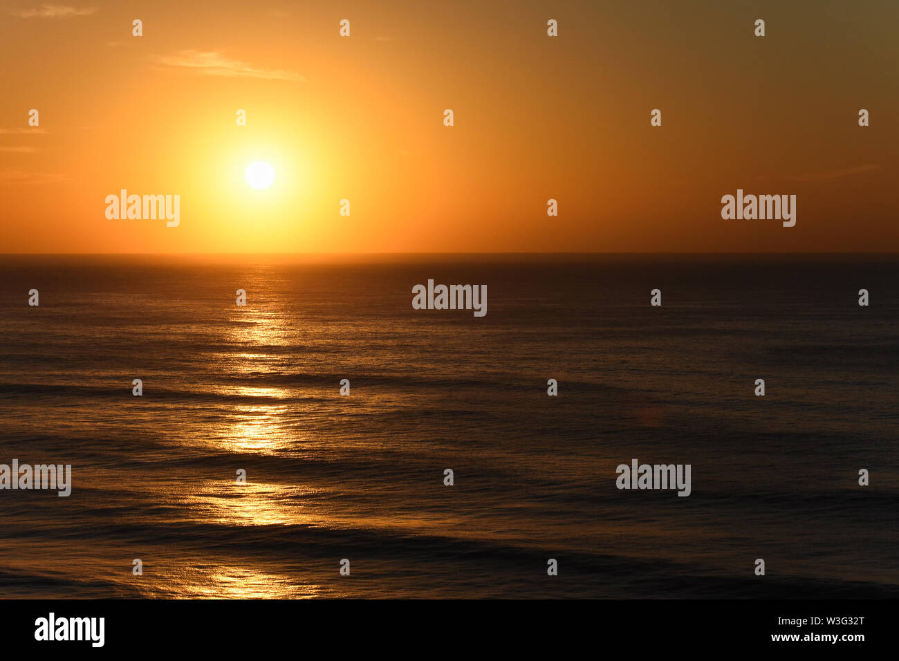 Orange Clear Sky Sunrise Over The Ocean Stock Photo - Alamy