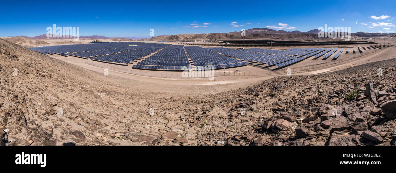 Hundreds solar energy modules or panels rows along the dry lands at Atacama Desert, Chile. Huge Photovoltaic PV Plant in the middle of the desert Stock Photo