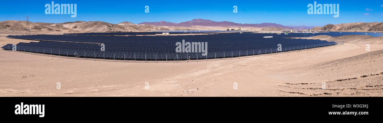 Hundreds solar energy modules or panels rows along the dry lands at Atacama Desert, Chile. Huge Photovoltaic PV Plant in the middle of the desert Stock Photo